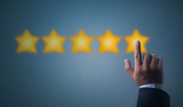 excellent service and best customer experience or good client , business man pointing at 5 stars rating on dark blue background  (excellent service and best customer experience or good client , business man pointing at 5 stars rating on dark blue back